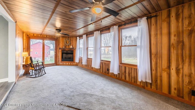 unfurnished sunroom with ceiling fan and wooden ceiling