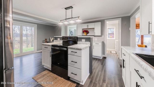 kitchen featuring white cabinetry, electric range, pendant lighting, and a healthy amount of sunlight