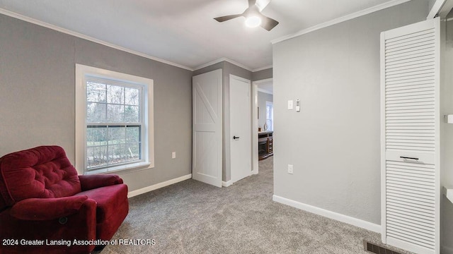 living area with light carpet, crown molding, and ceiling fan