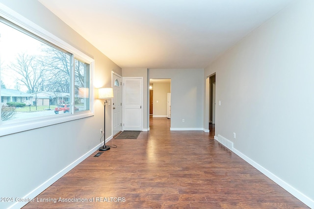 spare room with dark wood-type flooring