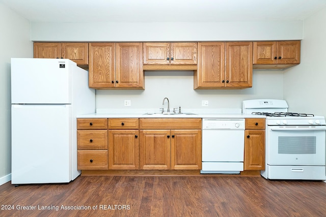 kitchen with dark hardwood / wood-style flooring, sink, and white appliances