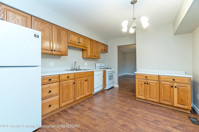 kitchen featuring white appliances, an inviting chandelier, sink, hanging light fixtures, and dark hardwood / wood-style flooring