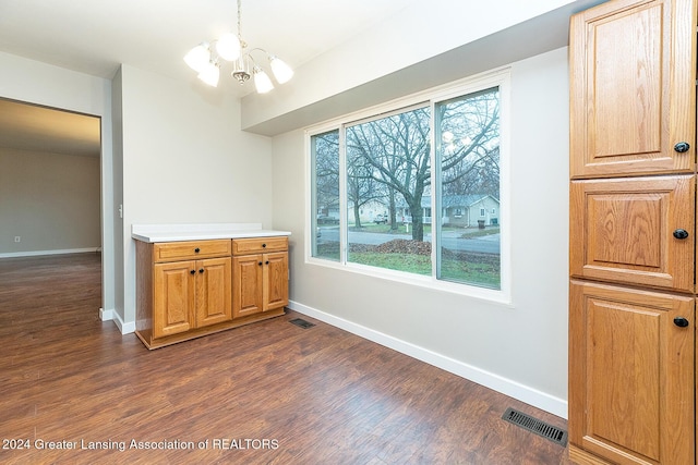 dining room featuring dark hardwood / wood-style floors and a notable chandelier