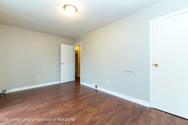 spare room with dark hardwood / wood-style flooring