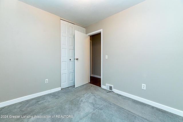 unfurnished bedroom with carpet flooring and a closet