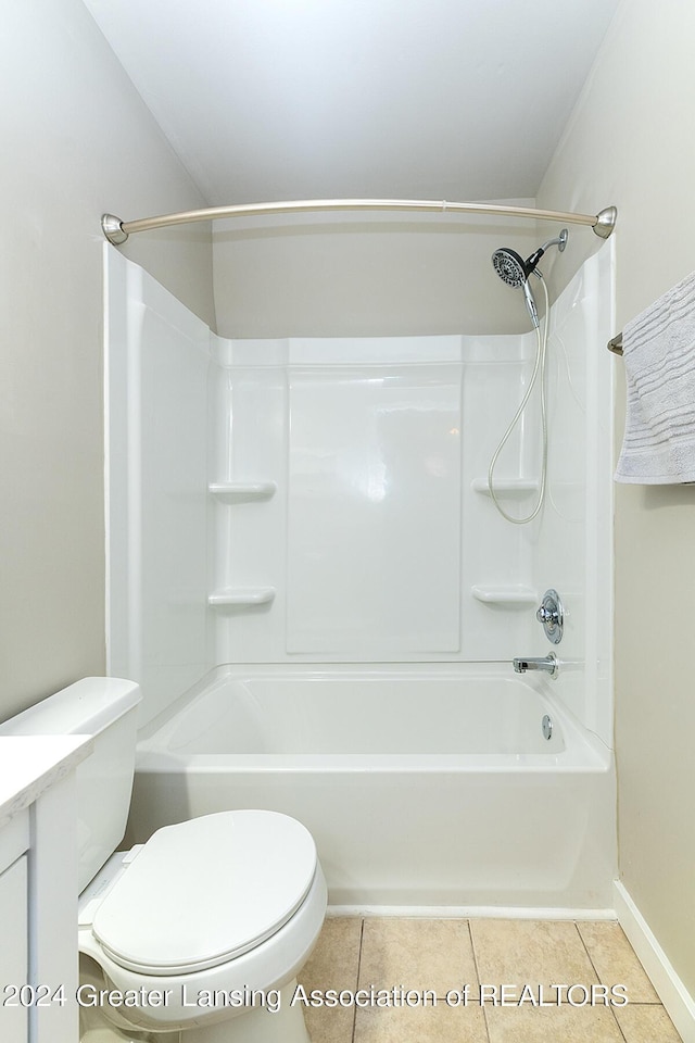 bathroom with tile patterned flooring, shower / bathing tub combination, and toilet