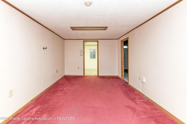 carpeted spare room featuring a textured ceiling and crown molding