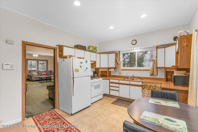 kitchen featuring white cabinetry, white appliances, sink, and ornamental molding