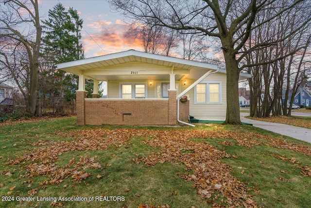 view of front of property with a lawn and covered porch