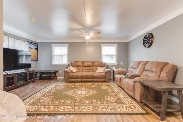 living room with hardwood / wood-style floors, a wealth of natural light, and ceiling fan