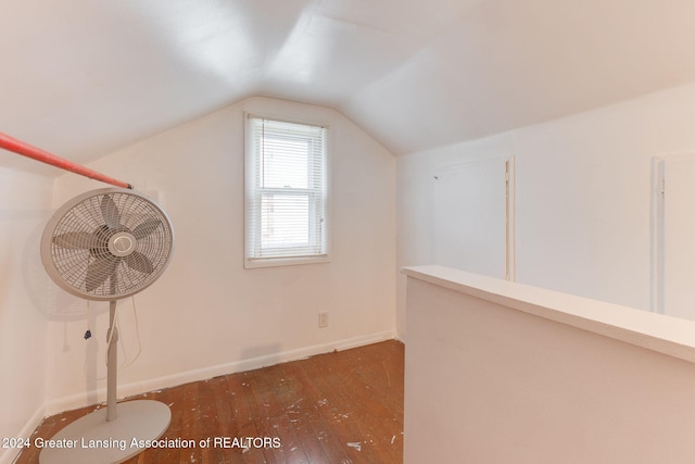 additional living space with dark hardwood / wood-style floors and vaulted ceiling