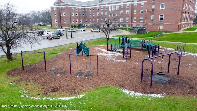 view of home's community with a playground and a yard