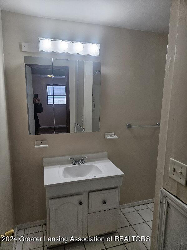 bathroom with tile patterned flooring and vanity