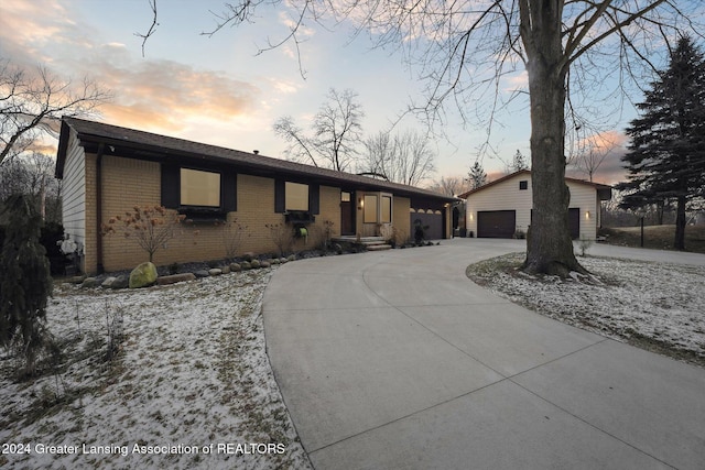 ranch-style home featuring an outbuilding and a garage