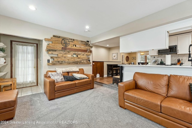 living room featuring a healthy amount of sunlight and light colored carpet