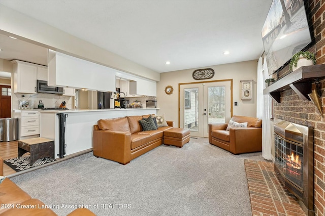 living room featuring french doors and light colored carpet