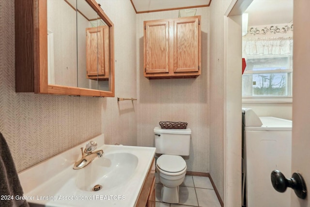 bathroom with toilet, washer / dryer, vanity, and tile patterned floors