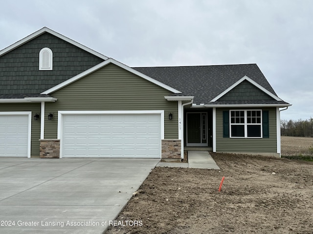 1480 Superior Dr Unit 24, Saint Johns, MI 48879 - view of front of home with driveway, an attached garage, and a shingled roof