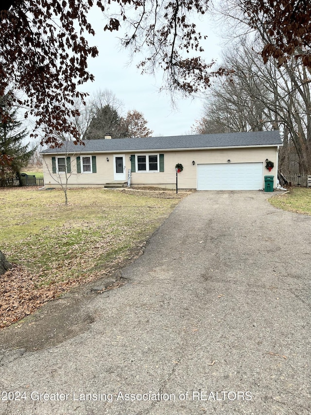 ranch-style house with a garage and a front yard