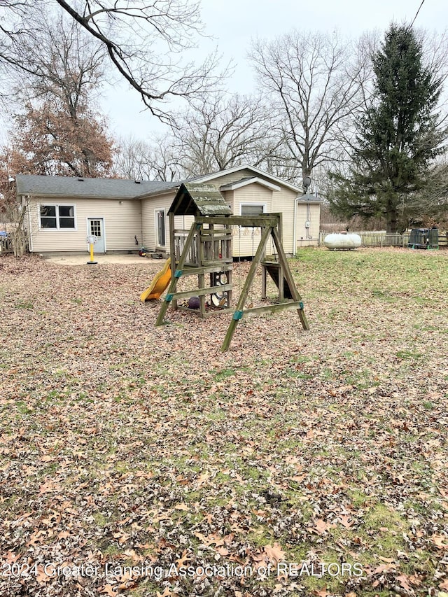 view of playground with a patio area