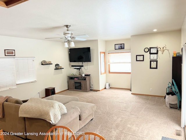 living room with ceiling fan and light colored carpet