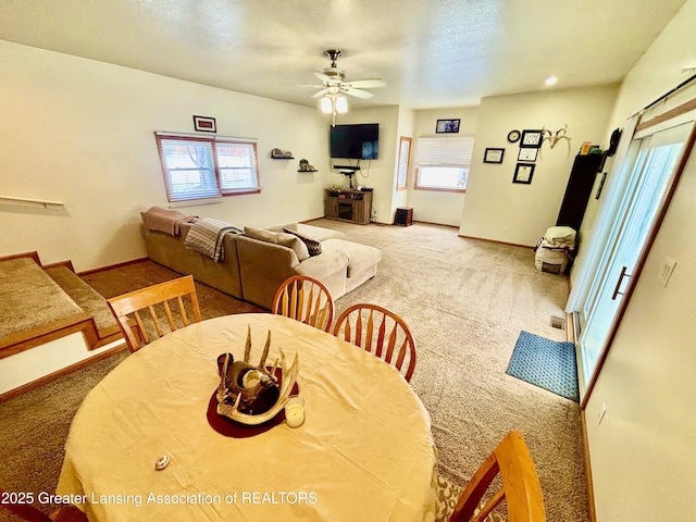 dining room with carpet and ceiling fan