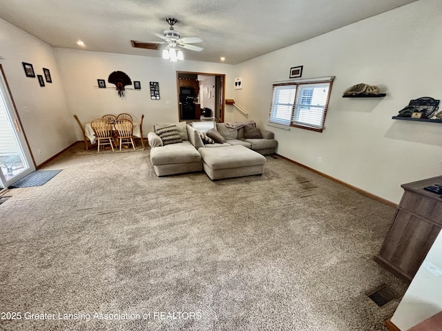 carpeted living room featuring ceiling fan