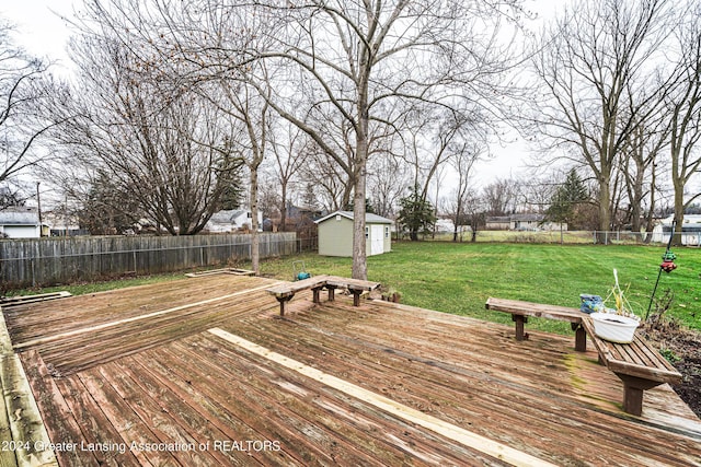 deck featuring a yard and a shed