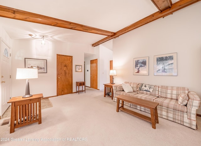 living room featuring beam ceiling and carpet