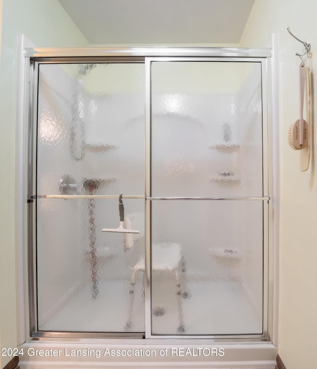 bathroom with a shower with door