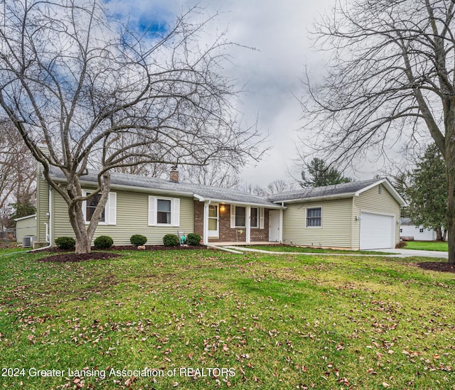 ranch-style house featuring cooling unit, a front yard, and a garage