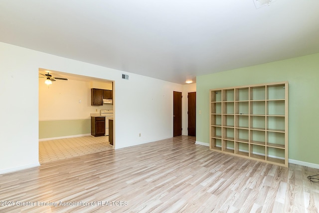 empty room with light wood-type flooring and ceiling fan