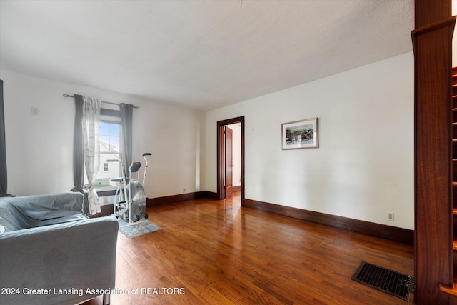 living room featuring a textured ceiling and hardwood / wood-style flooring