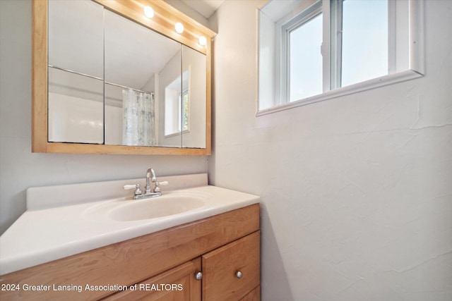 bathroom with vanity and curtained shower