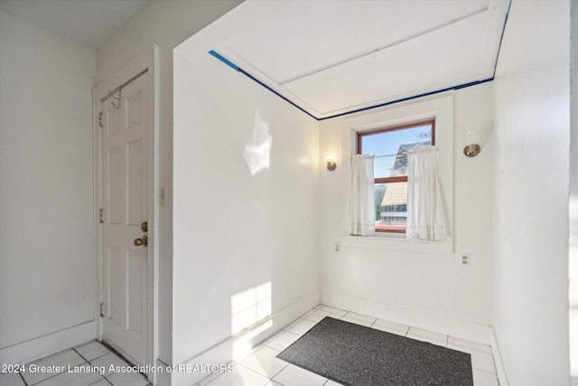 hall with light tile patterned floors