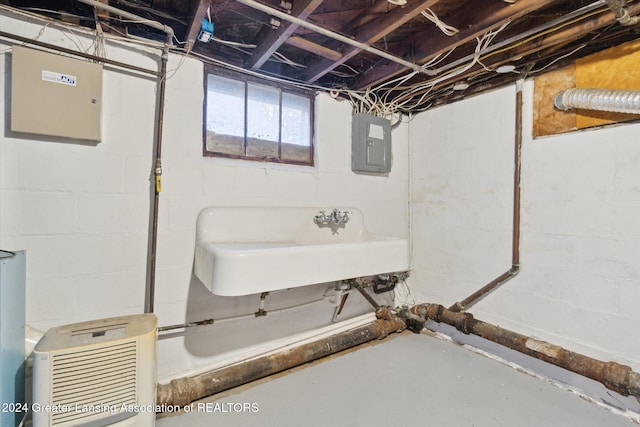 basement with sink and electric panel