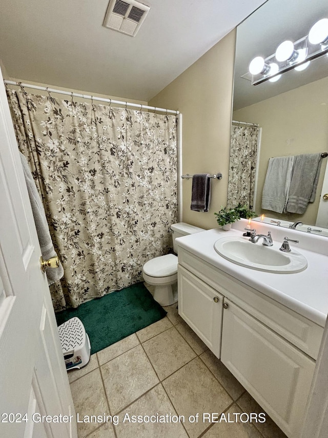 bathroom featuring toilet, vanity, and tile patterned floors