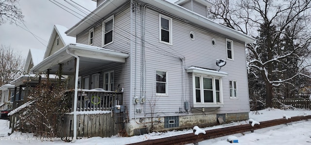 view of snow covered exterior featuring a porch