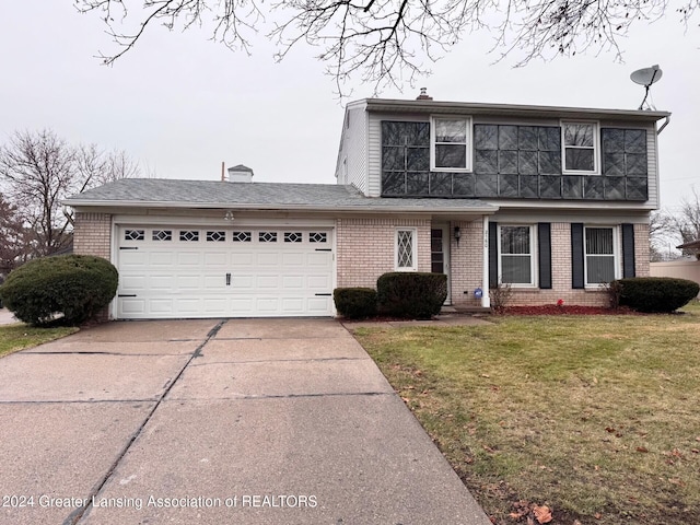 view of front property featuring a garage and a front lawn