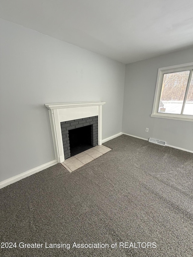 unfurnished living room with a fireplace and light carpet