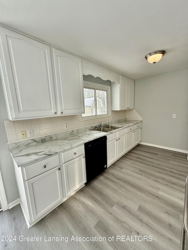 kitchen featuring dishwasher, white cabinetry, sink, and light hardwood / wood-style flooring