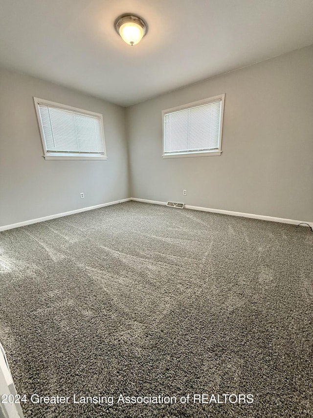 unfurnished room featuring carpet flooring