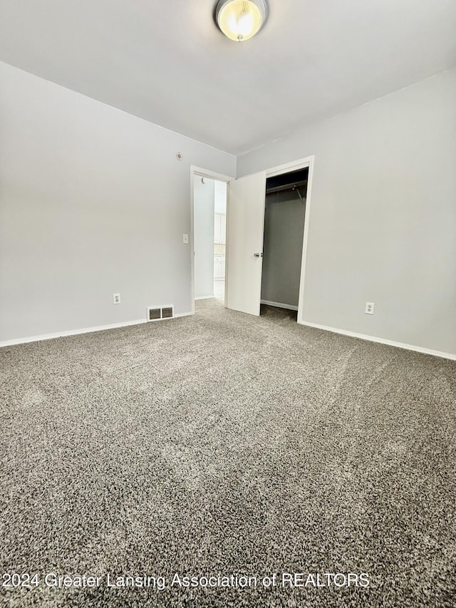 unfurnished bedroom with a closet and carpet