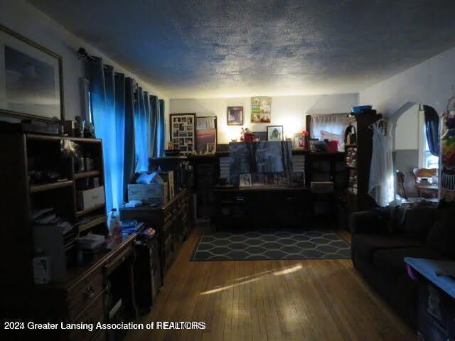 living room featuring hardwood / wood-style flooring and a textured ceiling