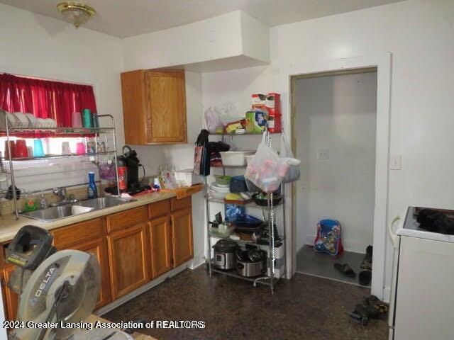 kitchen featuring white range with electric stovetop and sink