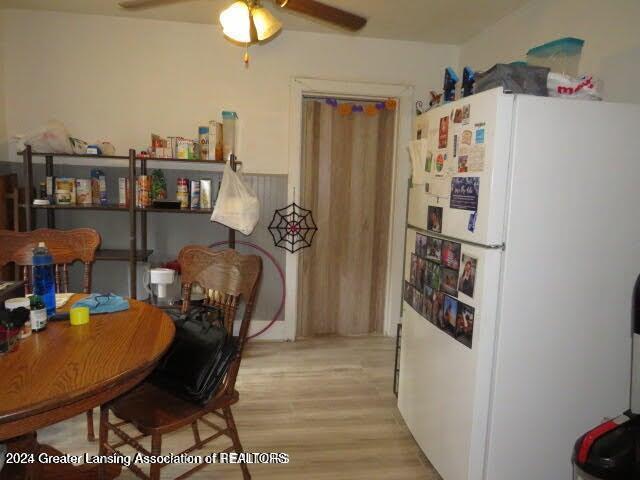 dining space with ceiling fan and light hardwood / wood-style floors