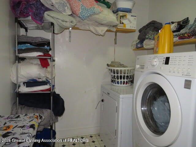 clothes washing area with washing machine and dryer