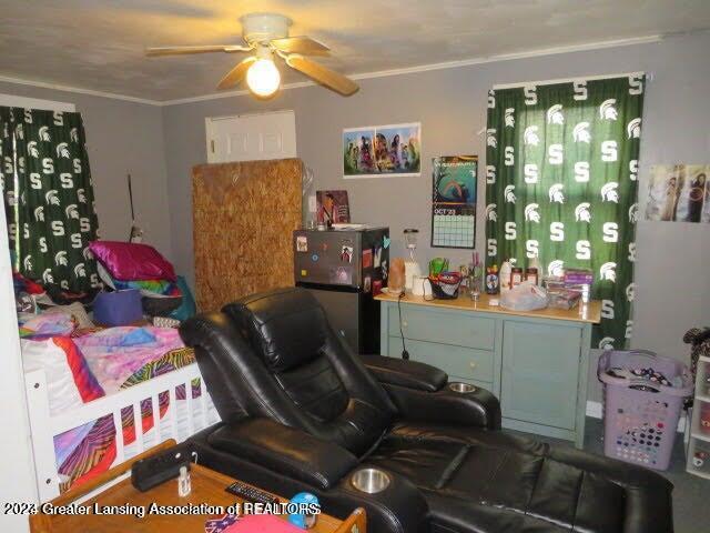 bedroom with ceiling fan and ornamental molding