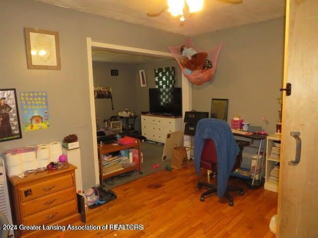 office space with ceiling fan and light wood-type flooring