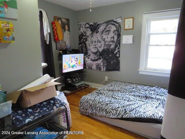 bedroom with hardwood / wood-style floors